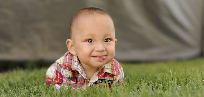 Baby Uriah Fuller crawling on grass