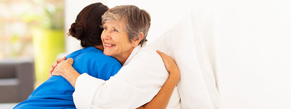 Caregiver hugging a patient