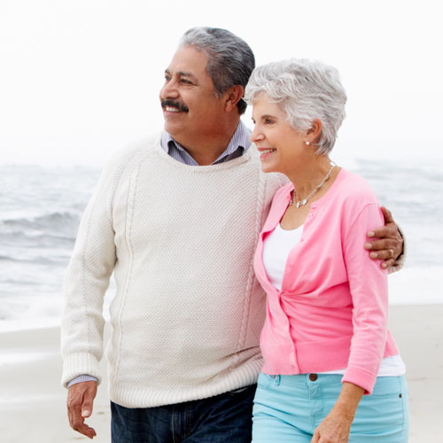 Senior couple walking on beach