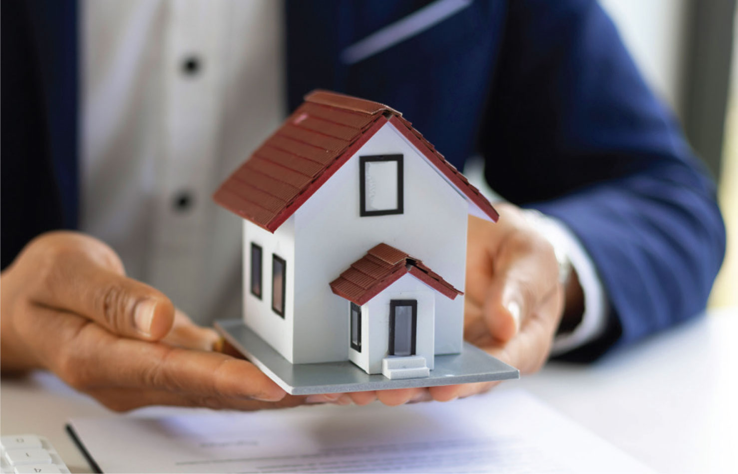 Small house being held in hands